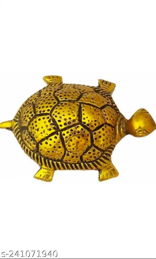 Golden tortoise figurine in a clear plate on top of a book. Perfect for home decor, office display, or as a thoughtful gift
