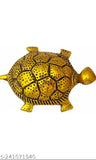 Golden tortoise figurine in a clear plate on top of a book. Perfect for home decor, office display, or as a thoughtful gift