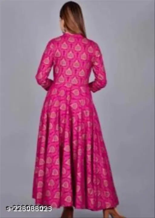 Pink gold print maxi dress, long sleeves, flowy fabric, ideal for festive occasions.