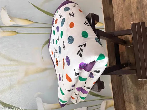 Multi-colored quilt with a polka dot pattern, possibly for kids or used as a decorative pillow