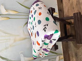 Multi-colored quilt with a polka dot pattern, possibly for kids or used as a decorative pillow