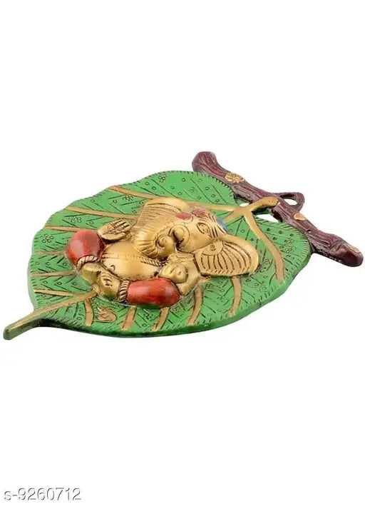 Metal Ganesh idol, Fashion Bizz religious figurine on leaf, Indian handcrafted artifact