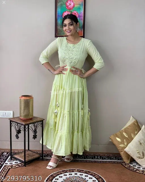 Light green cotton embroidery flared anarkali gown, features mirror work and tassels, suitable for women's party wear