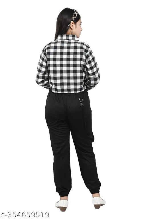 A girl in a black and white checkered dress set, posing against a white background