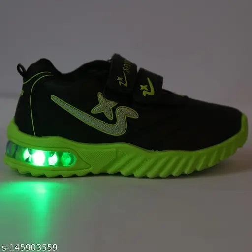 Green and black sport running shoe with reflective LED lights, velcro closure, suitable for kids