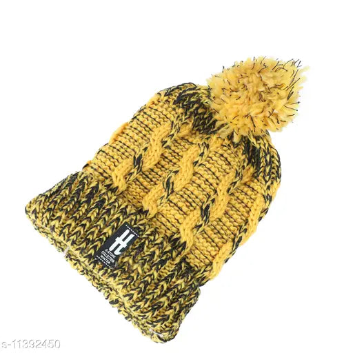 Knitted yellow wool cap with a pom pum and a ribbed texture
