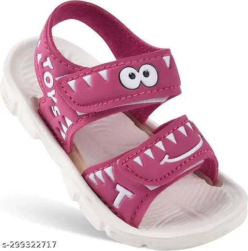 Pink kids sandals with monster teeth design, featuring a zipper on the back and straps around the ankles
