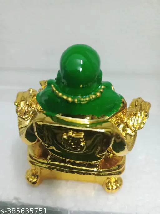 A small, green glass laughing Buddha figurine on a shelf