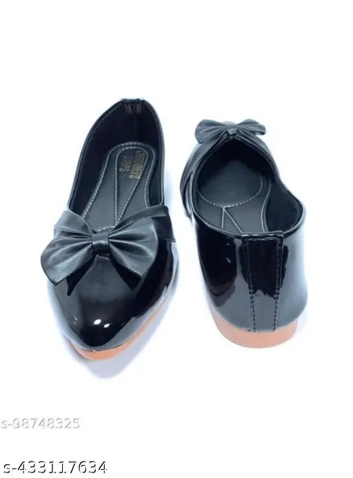 Black velvet bow shoes on display