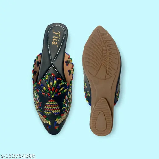 Black synthetic bell-shaped mules by FiiA, embellished with embroidery and Swarovski elements. Perfect for daily wear with kurtas, kurtis, ethnic motifs, jeans, dresses etc. Ankle loop fastening. Indian-made
