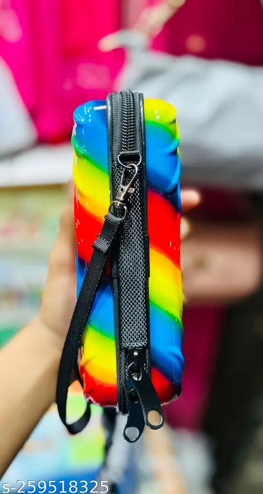 Young, black sling bag with rainbow stripes