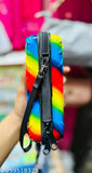 Young, black sling bag with rainbow stripes