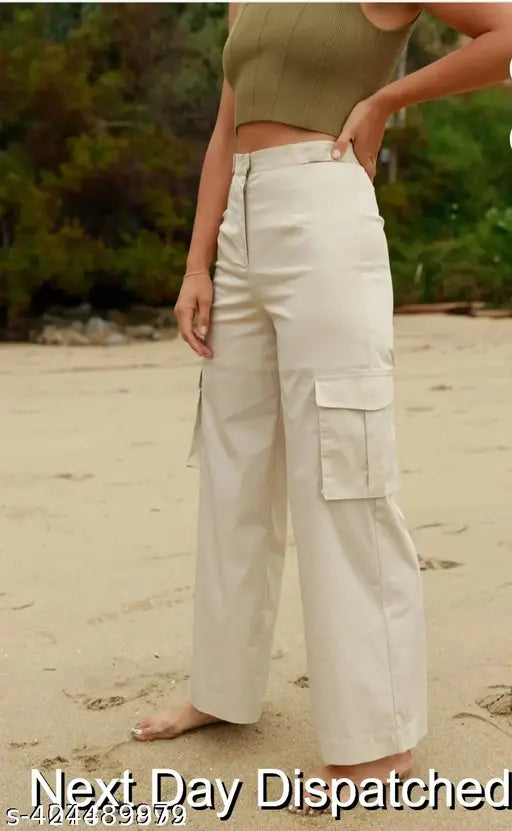 Cream cargo pants with a slanted inset pocket, high rise design, patch with flap closure, straight fit, stretchable material, relaxed waistband, suitable for casual and formal wear. Trousers for women