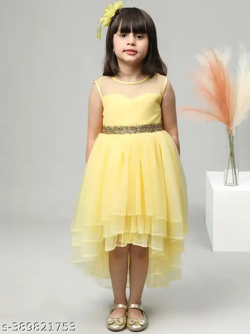 Yellow tulle dress with a yellow sash and a gold bow at the waist