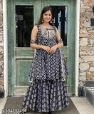 Woman in dark blue rayon printed kurta with sharara and dupatta set, outdoor daylight, stone wall background