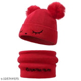 Red winter beanie with ear flaps and a cute face on top, suitable for kids