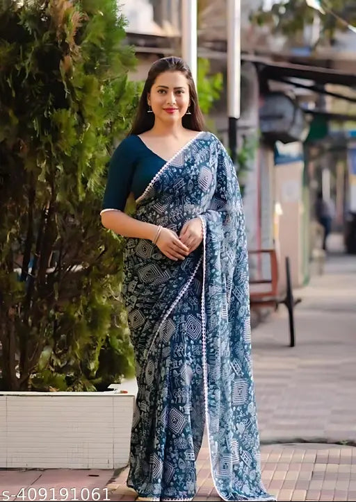 A woman wearing a long blue georgette saree with a shimmering fabric