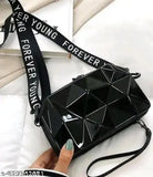 Black crossbody sling bag with 'Forever Young' written on strap, metallic studs and diamond shapes
