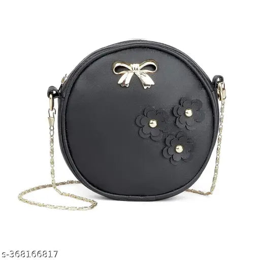Pink and black handbag with a cross body strap and floral embellishments