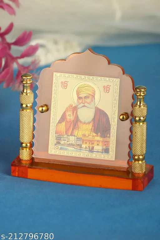 Orange-tinted glass Guru Nanak idol with metallic pillars, decorative item for home, office, or car