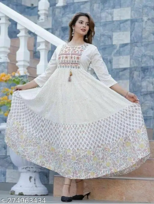 A woman's long layered anarkali kameez with a multi-print embroidered yoke in white color, featuring a full skirt and a sleeveless design
