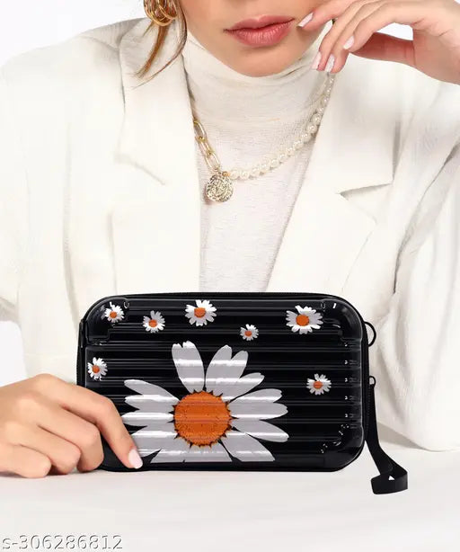 Small suitcase-style sling bag with a handbag carry strap