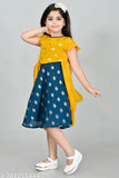 A young girl posing in a traditional South Asian style dress, with a black border and yellow details