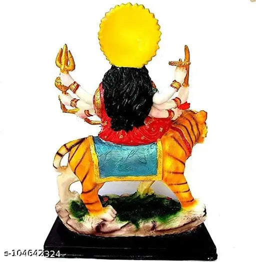 This is a figurine of the Indian Goddess Durga, cast in metal with gold accents, holding a spear and positioned on a pedestal. It is an idol meant for spiritual puja or decoration purposes