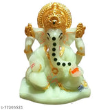 Green and gold enamel statue of Lord Ganesh with a serene expression
