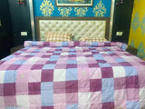 Royal blue and pink checkered comforter on a double bed, Pearl Brand, soft cotton fabric, quilted design, all-weather material