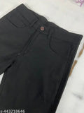 Black high-rise jeans for men, distressed detailing on a plain black background with visible zipper fly, black denim fabric, slim fit shape