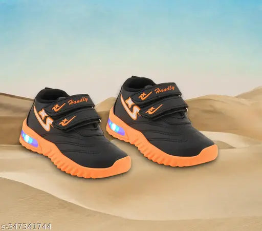 Black and orange kids' led sneakers with velcro closure, featuring bright light-up soles and a sporty design