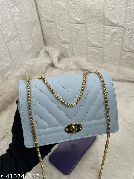 Blue quilted sling bag with twist lock, multiple card slots