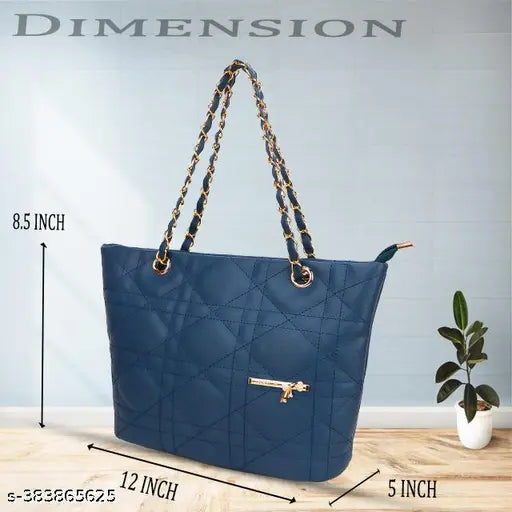 Ladies blue quilted shoulder bag with gold zippers and black handle