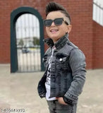 A young boy in a grey zip-up jacket smiling