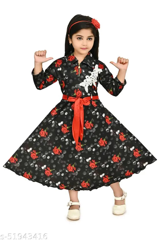 A young girl in a black and red floral dress with puffy sleeves