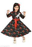 A young girl in a black and red floral dress with puffy sleeves