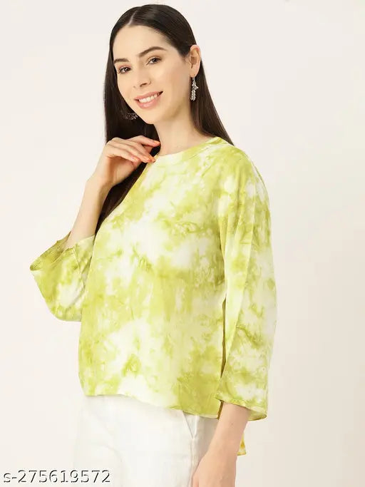 Green off-white rayon top with dyed net all-over print, three-quarter sleeves, round neckline, curved hemline. Made in India