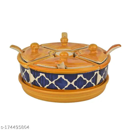 Masala container with lid and spoon, part of a four-jar set, in vibrant yellow-blue handpainted ceramic design, on a matching salt dispenser, in a local store