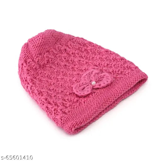 A dark pink knitted beanie with a bow accent inside a woolen fur lining, featuring a floral pattern