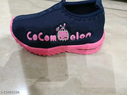 Pink and black sports shoe with pink laces, pink cuff, coconut written on it