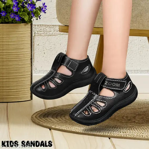 A child's black sandal with straps