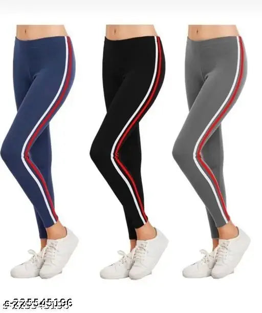 Three pairs of women's leggings, featuring black with red and blue stripes, blue with white and navy stripes, and gray with red and blue stripes