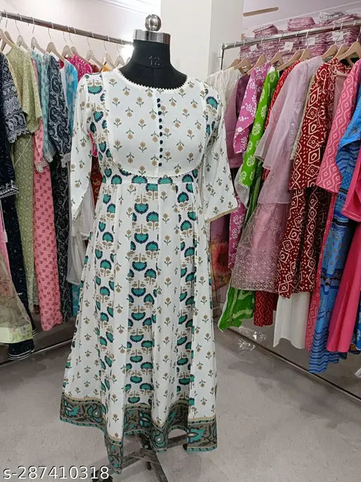 White and blue printed kameez with dupatta on a hanger in a shop