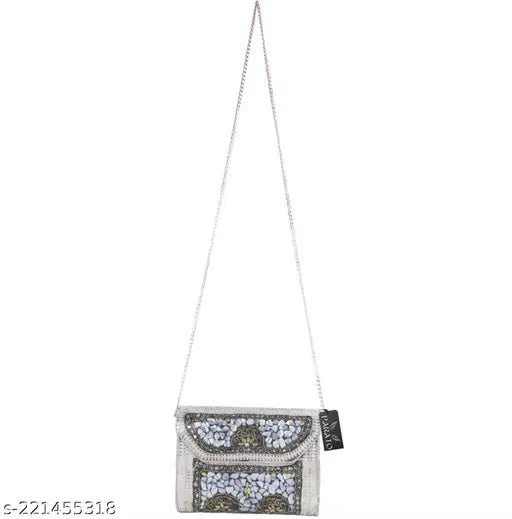 Silver metal sling bag clutch, with visible silver chain straps and a zip closure. Suitable for parties and events