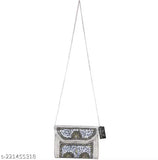 Silver metal sling bag clutch, with visible silver chain straps and a zip closure. Suitable for parties and events