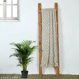 A single-layer, grey throw blanket with fringes, ideal for a bed or couch. Measures 50 by 60 inches in length and width