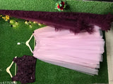 Pink jute silk net chaniya choli with wine blouse, embellished top on display. Semi-stitched Indian bridal lehenga set for weddings, parties." (105 characters)