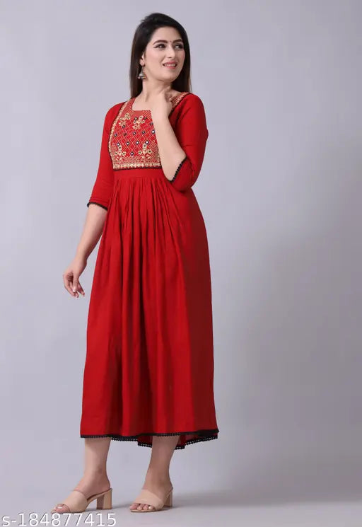 Maroon kurti dress, embroidered detailing, flowy silhouette, cotton fabric.