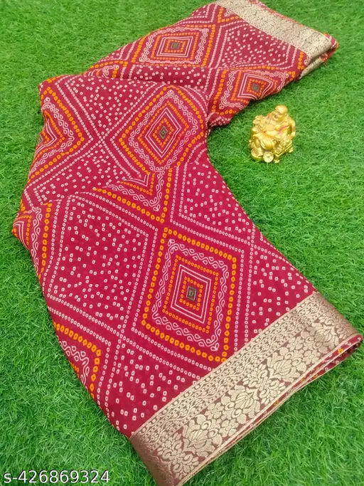 A vibrant red bandhani saree with yellow border, laid out flat for display. This traditional women's saree features intricate patterns and designs typical of bandhani style, making it a versatile choice for formal events or celebrations